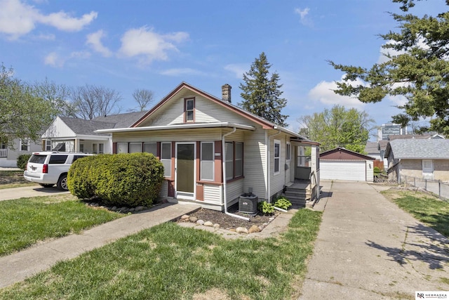 4504 Mayberry St, Omaha, NE 68106 - bungalow featuring a garage, central AC, fence, a chimney, and an outbuilding
