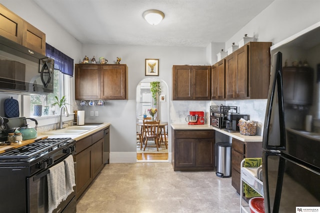 4504 Mayberry St, Omaha, NE 68106 - kitchen featuring a sink, black appliances, and light countertops