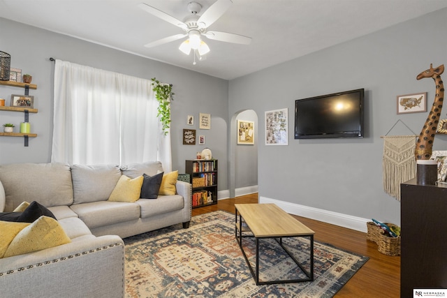 4504 Mayberry St, Omaha, NE 68106 - living area with arched walkways, baseboards, a ceiling fan, and wood finished floors