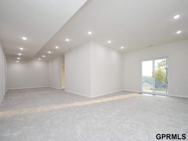 unfurnished room featuring recessed lighting, baseboards, and light colored carpet
