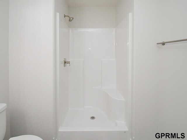 full bath with toilet and a shower