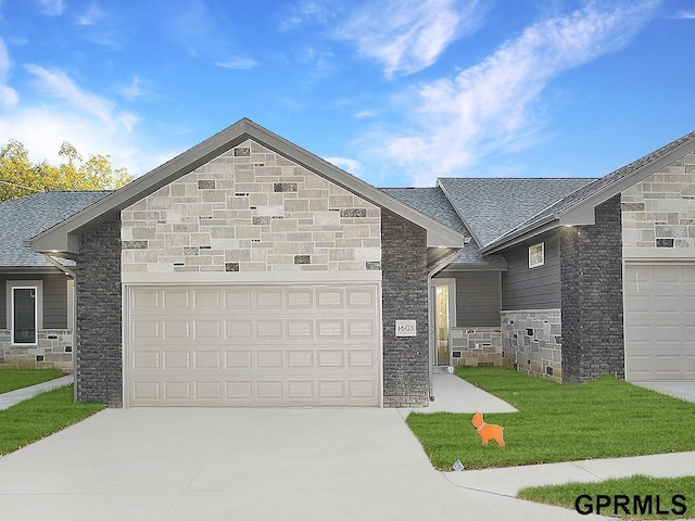 view of front facade with concrete driveway, stone siding, an attached garage, and a front yard