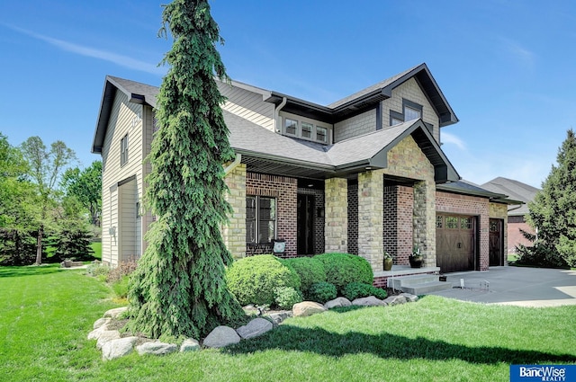 craftsman-style home featuring a garage, concrete driveway, a front lawn, stone siding, and a shingled roof
