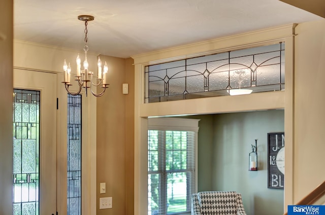 doorway to outside with a chandelier and plenty of natural light