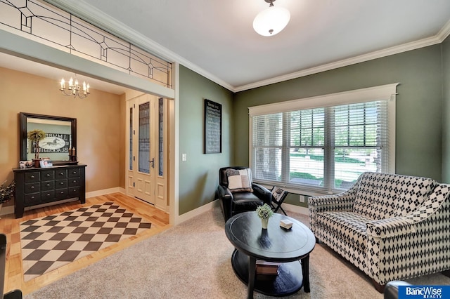 living area featuring crown molding, a chandelier, baseboards, and wood finished floors