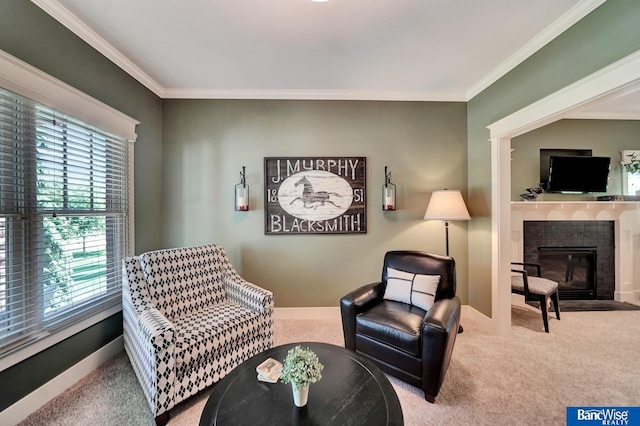 living area with carpet floors, ornamental molding, a tile fireplace, and baseboards