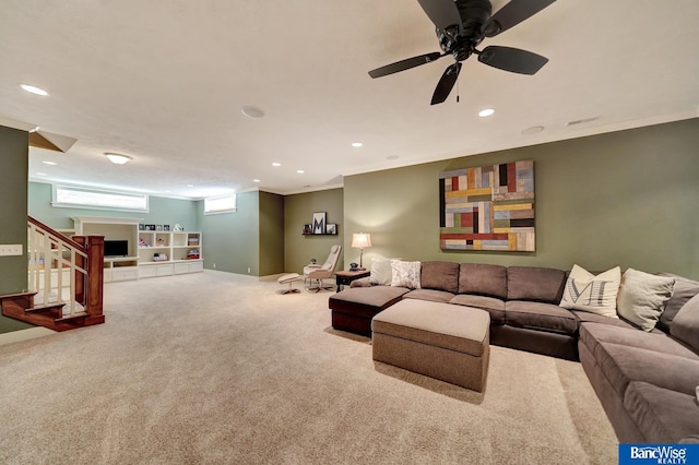 living area featuring carpet floors, stairway, recessed lighting, crown molding, and a ceiling fan