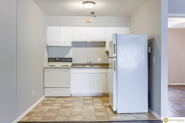 kitchen featuring a sink, white appliances, white cabinetry, baseboards, and under cabinet range hood