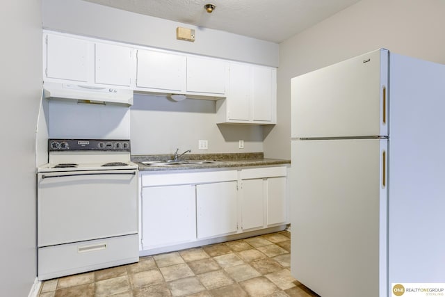 kitchen with a sink, white appliances, white cabinetry, stone finish flooring, and under cabinet range hood