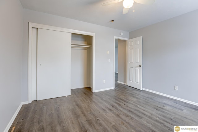 unfurnished bedroom featuring a closet, a ceiling fan, baseboards, and wood finished floors