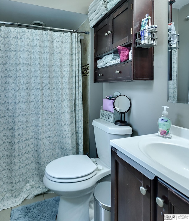 bathroom with vanity, tile patterned floors, toilet, and a shower with curtain
