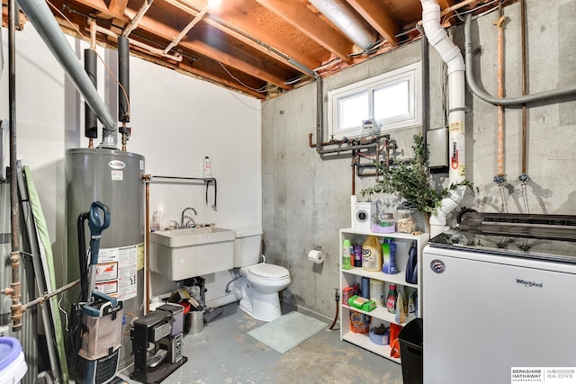 basement featuring a sink, gas water heater, fridge, and washer / clothes dryer