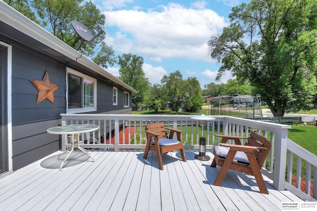 deck featuring a lawn and fence