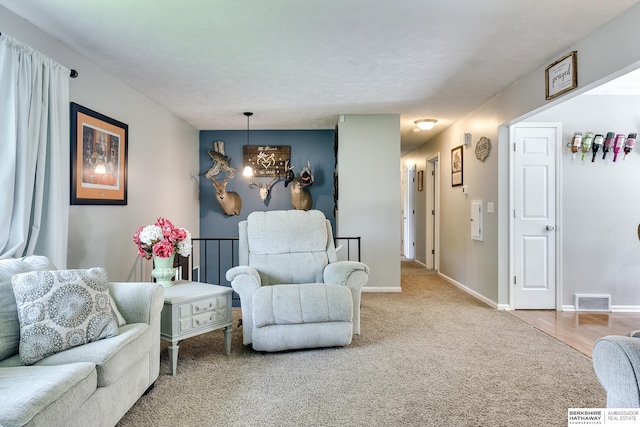 carpeted living area with visible vents, baseboards, and a chandelier