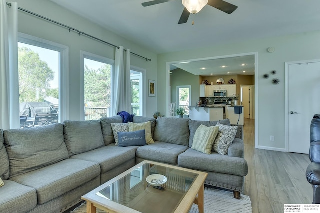 living area featuring light wood-style floors, recessed lighting, and ceiling fan