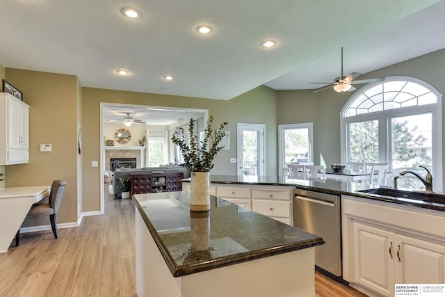 kitchen featuring a fireplace, recessed lighting, ceiling fan, and dishwasher