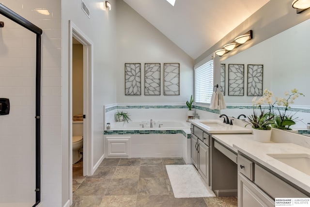 full bathroom with visible vents, a garden tub, double vanity, toilet, and a sink