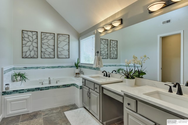 full bathroom featuring double vanity, visible vents, a sink, and a garden tub