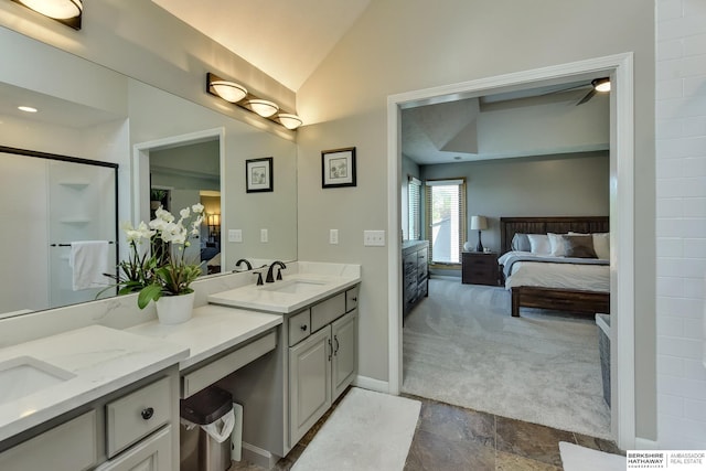 ensuite bathroom featuring vanity, a shower, baseboards, connected bathroom, and vaulted ceiling