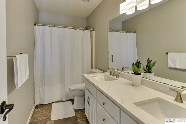 full bath featuring double vanity, toilet, visible vents, and a sink