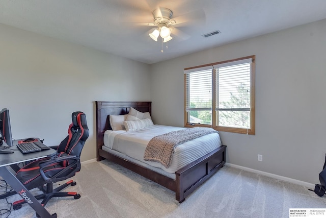 carpeted bedroom featuring baseboards, a ceiling fan, and visible vents