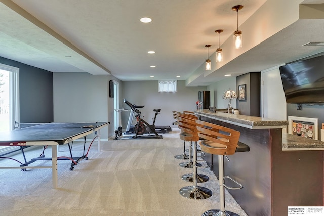 bar with light colored carpet, plenty of natural light, recessed lighting, baseboards, and indoor bar