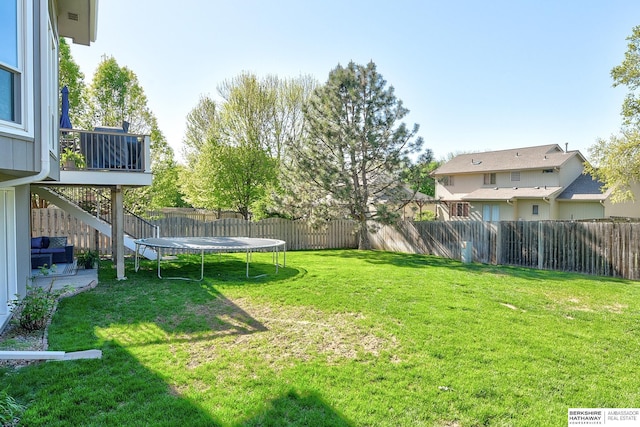 view of yard featuring a fenced backyard and a trampoline