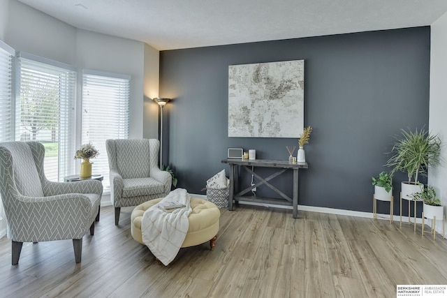 living area featuring baseboards and wood finished floors
