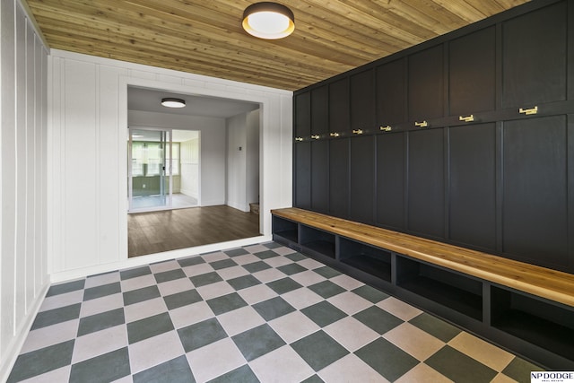 mudroom featuring wood ceiling and a decorative wall