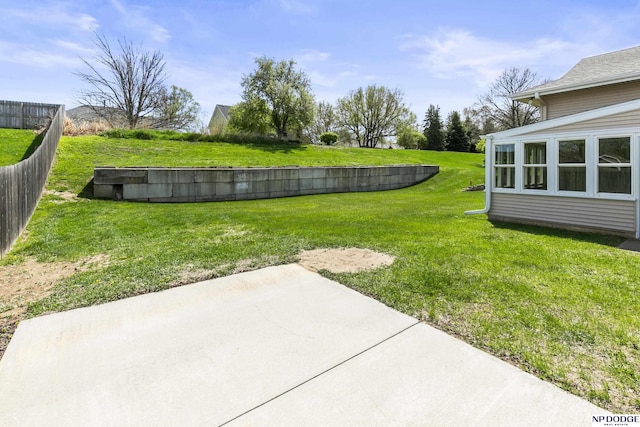 view of yard featuring fence and a patio