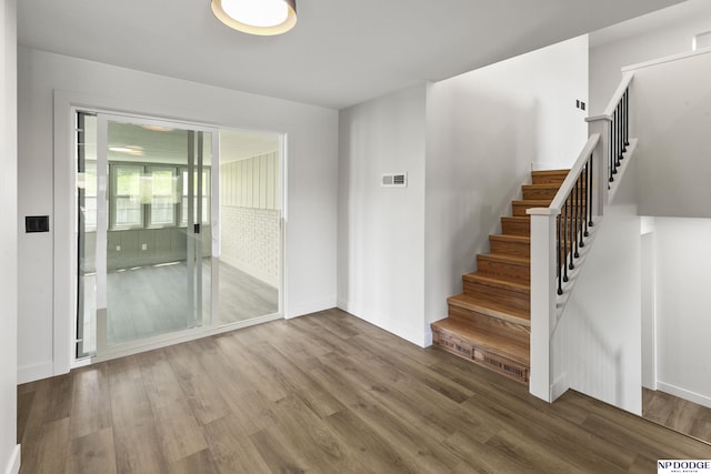 stairs with baseboards and wood finished floors