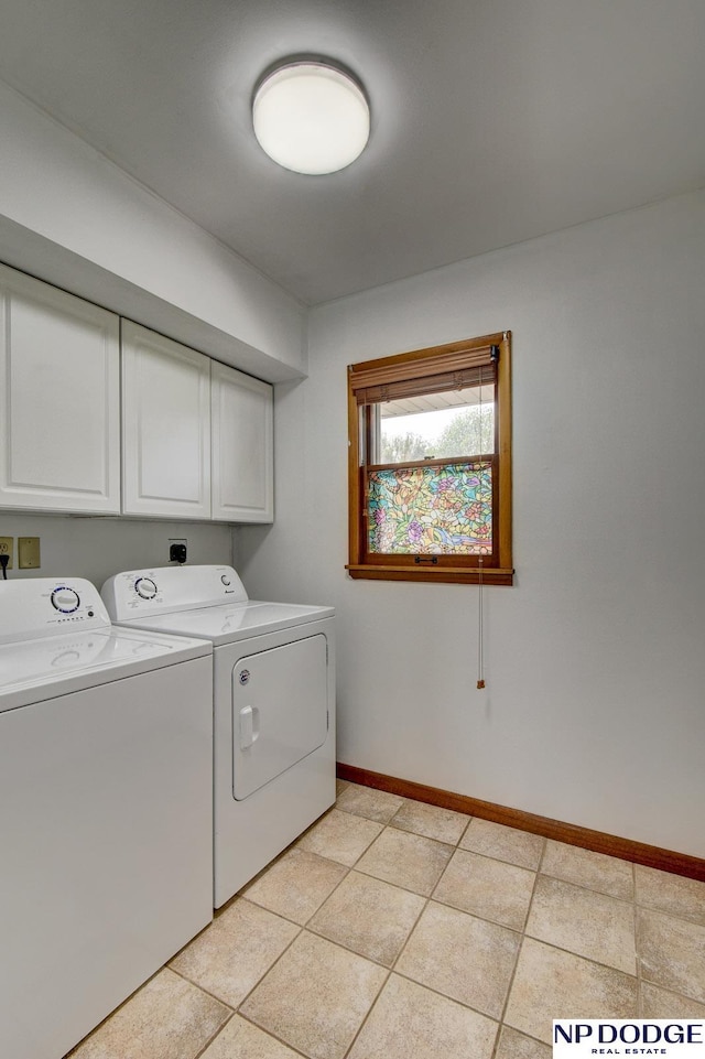 washroom featuring cabinet space, independent washer and dryer, baseboards, and light tile patterned floors