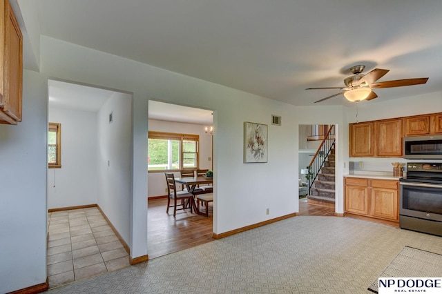 kitchen featuring light countertops, ceiling fan with notable chandelier, stainless steel appliances, baseboards, and visible vents