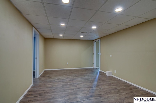 unfurnished room with recessed lighting, baseboards, a drop ceiling, wood finished floors, and visible vents