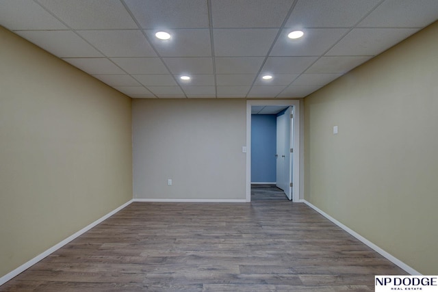 spare room featuring recessed lighting, baseboards, and wood finished floors
