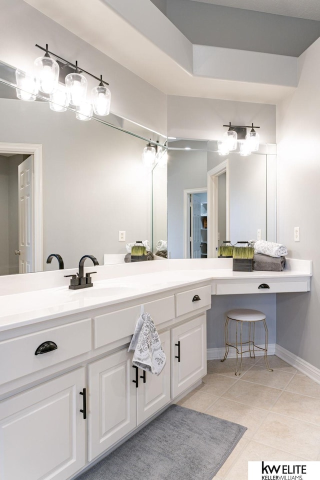 bathroom with baseboards, tile patterned flooring, and vanity