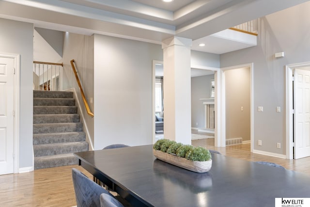dining room with visible vents, wood finished floors, stairway, ornate columns, and recessed lighting