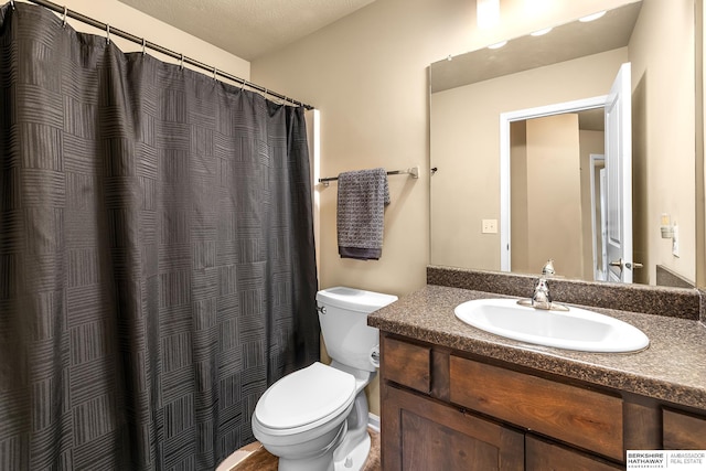 full bathroom with toilet and vanity