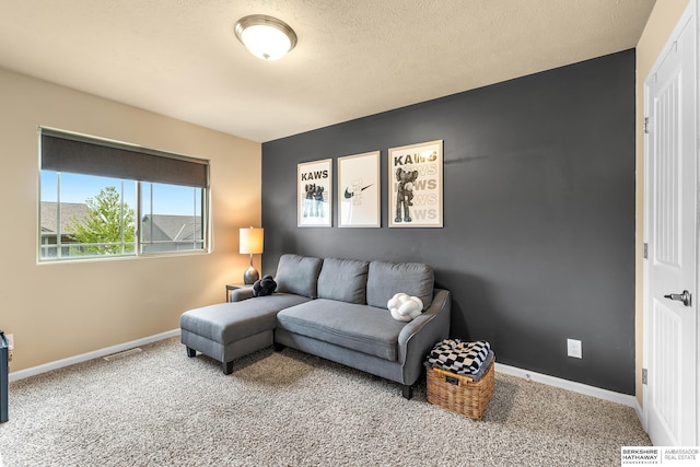 living area with carpet floors, baseboards, and visible vents