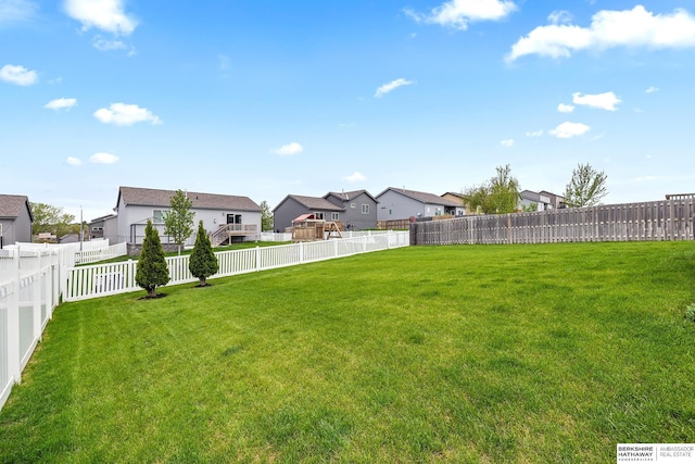 view of yard featuring a residential view and a fenced backyard