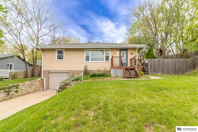 8514 Pinkney St, Omaha, NE 68134 - view of front of home featuring fence, an attached garage, driveway, and a front lawn