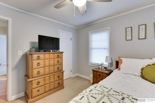 bedroom featuring crown molding, baseboards, a ceiling fan, and light colored carpet