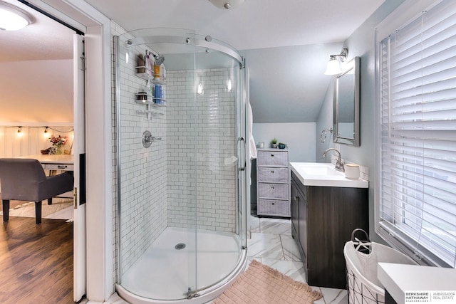 ensuite bathroom with vanity, connected bathroom, and a stall shower
