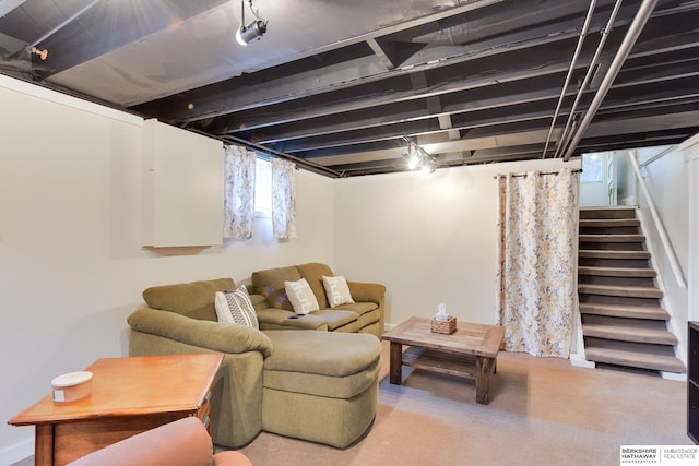 living room featuring stairs and carpet flooring