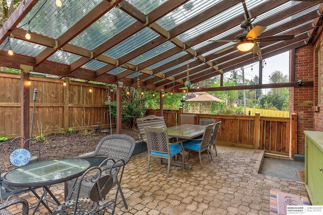 view of patio / terrace featuring a fenced backyard, outdoor dining space, and ceiling fan