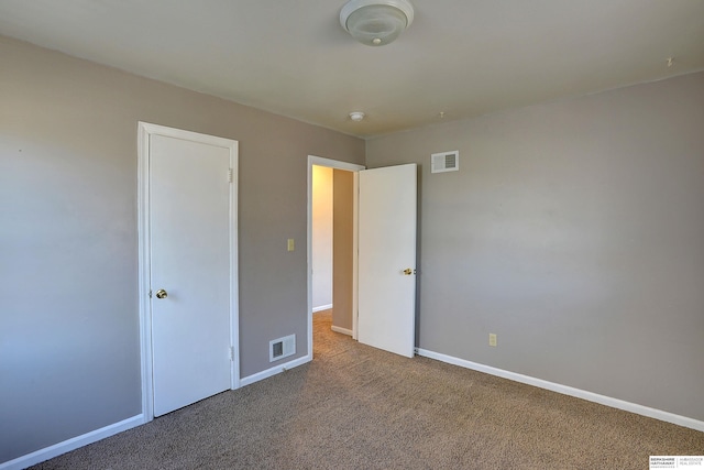 unfurnished bedroom with visible vents, baseboards, and carpet floors