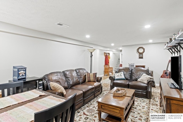 living room with recessed lighting and visible vents