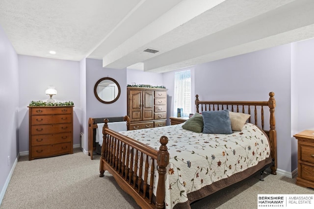 bedroom with baseboards, light carpet, a textured ceiling, and visible vents