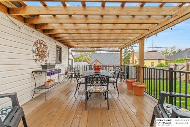 deck featuring a pergola, fence, and outdoor dining space