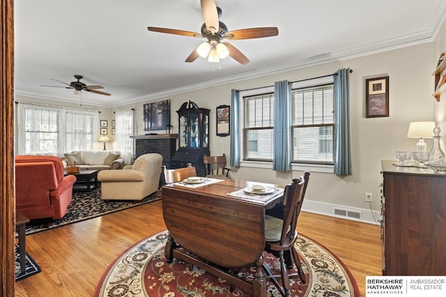 office area featuring visible vents, plenty of natural light, ceiling fan, and light wood-type flooring